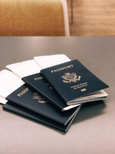 four passports with documents tucked in between the passport pages